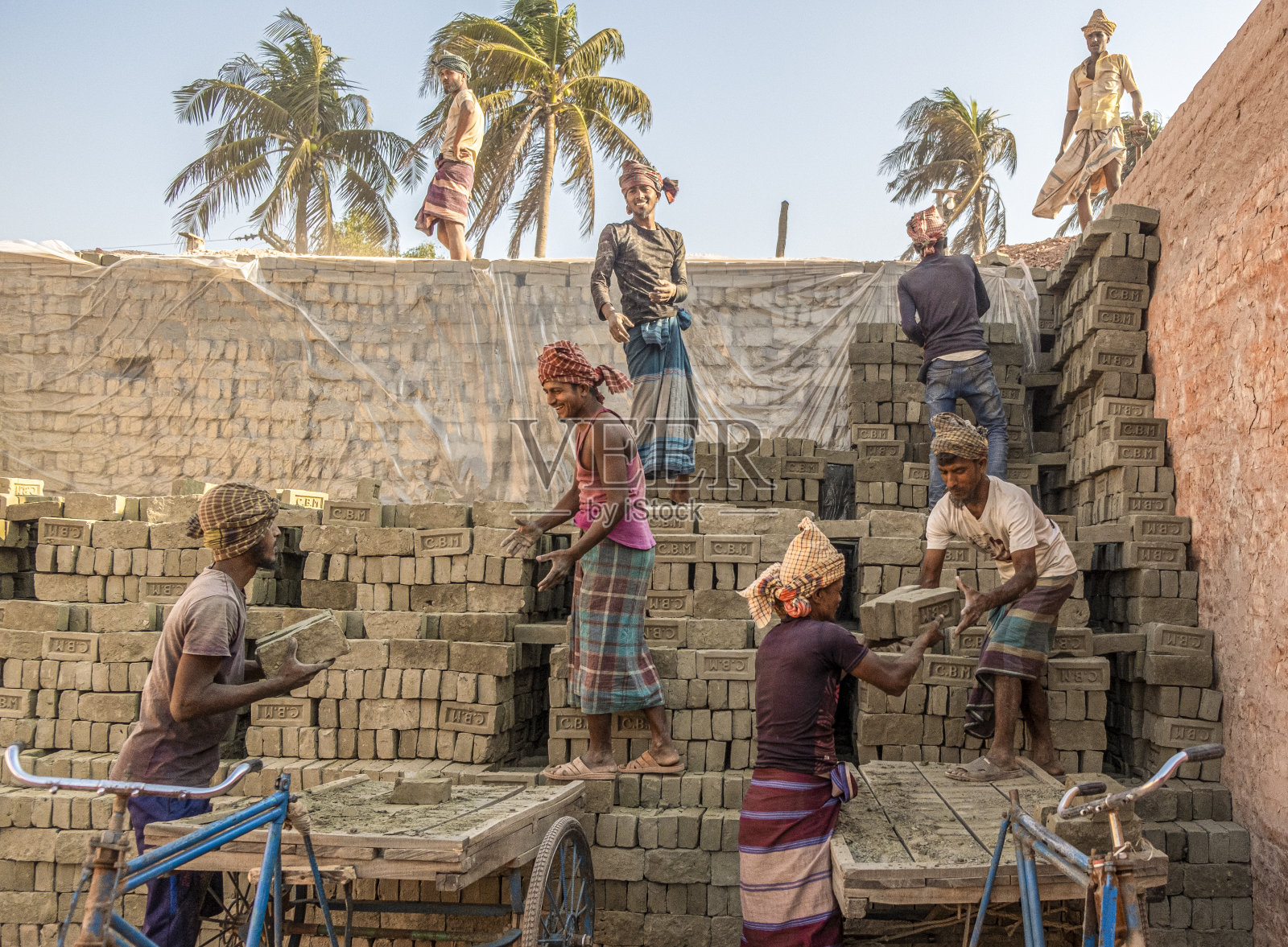 工人们在排砖。照片摄影图片