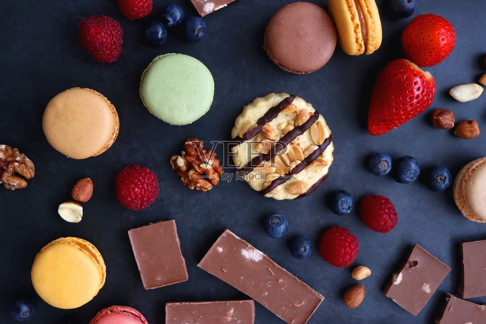 糖果，浆果和坚果在黑暗的背景照片摄影图片