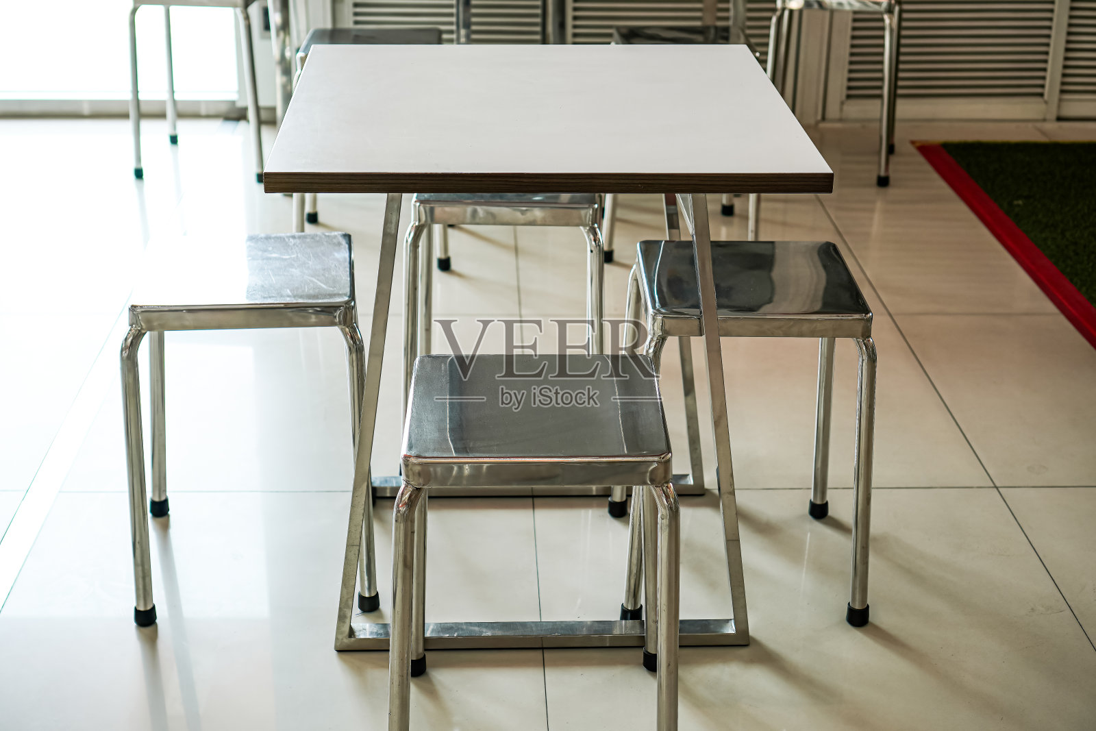 图为一个小的钢铝框架餐桌设置为3-4人坐在一起吃饭的自助餐厅。照片摄影图片