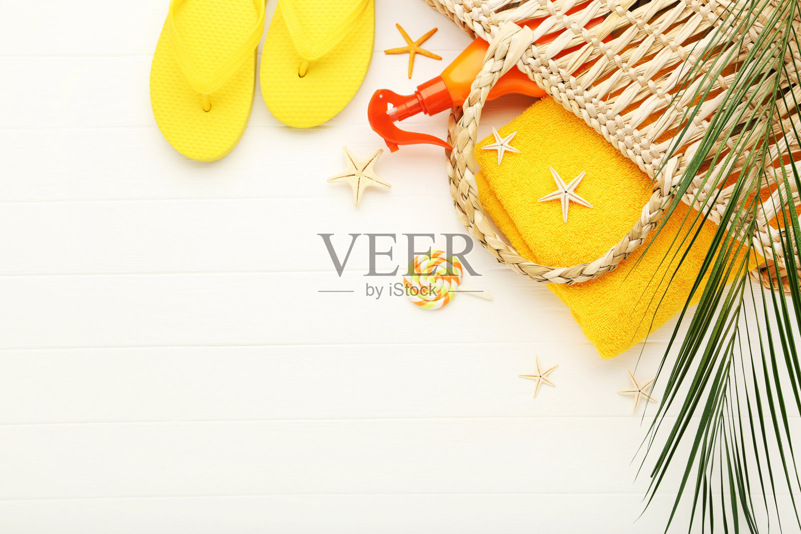 夏季包与人字拖，毛巾，海星和棕榈叶在白色木制背景照片摄影图片