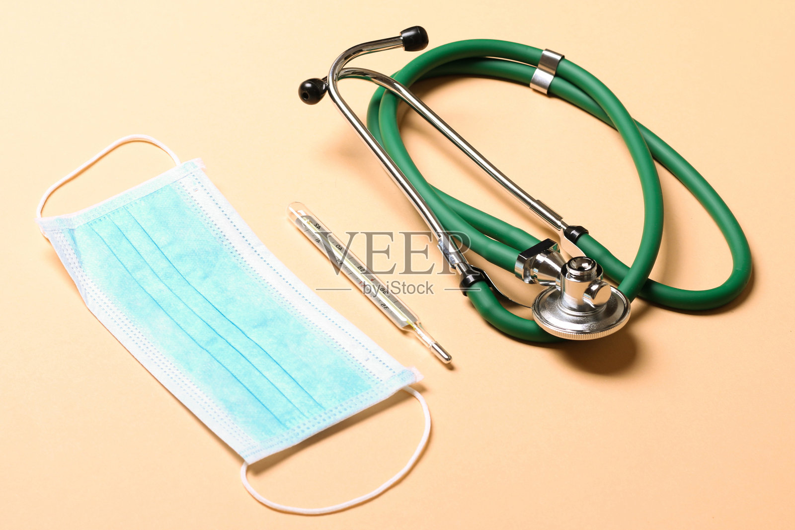 彩色背景听诊器、医用防护口罩、体温计俯视图。医疗配件概念照片摄影图片