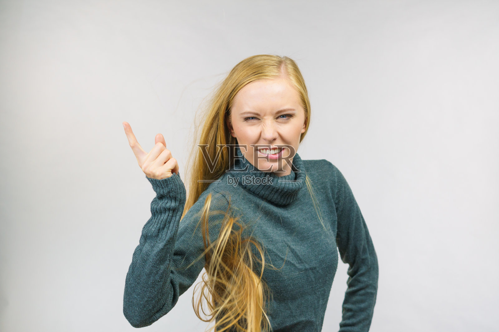 女人不高兴地用手指着照片摄影图片