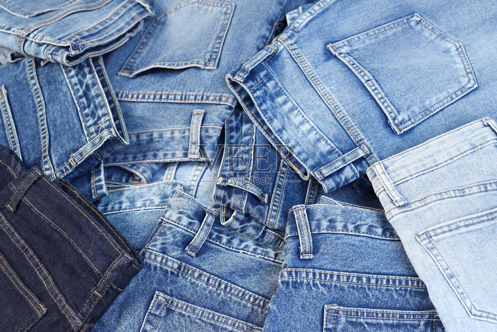 漂亮时尚的牛仔裤在牛仔裤店里一层层堆叠照片摄影图片