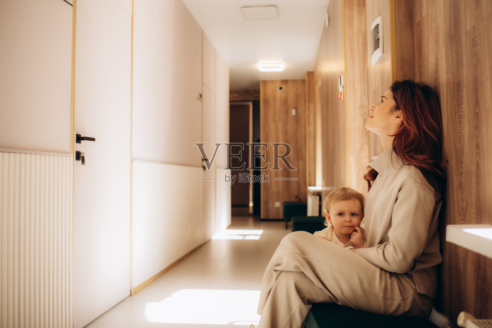 一对心烦意乱的母女在医院的走廊里等着医生照片摄影图片