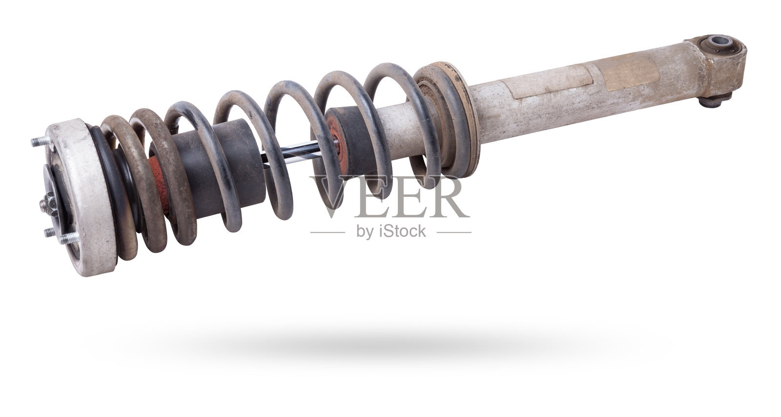 在汽车更换和维修期间使用的黑色弹簧减震器支柱在白色隔离背景上。使用过的备件。汽车配件目录。照片摄影图片