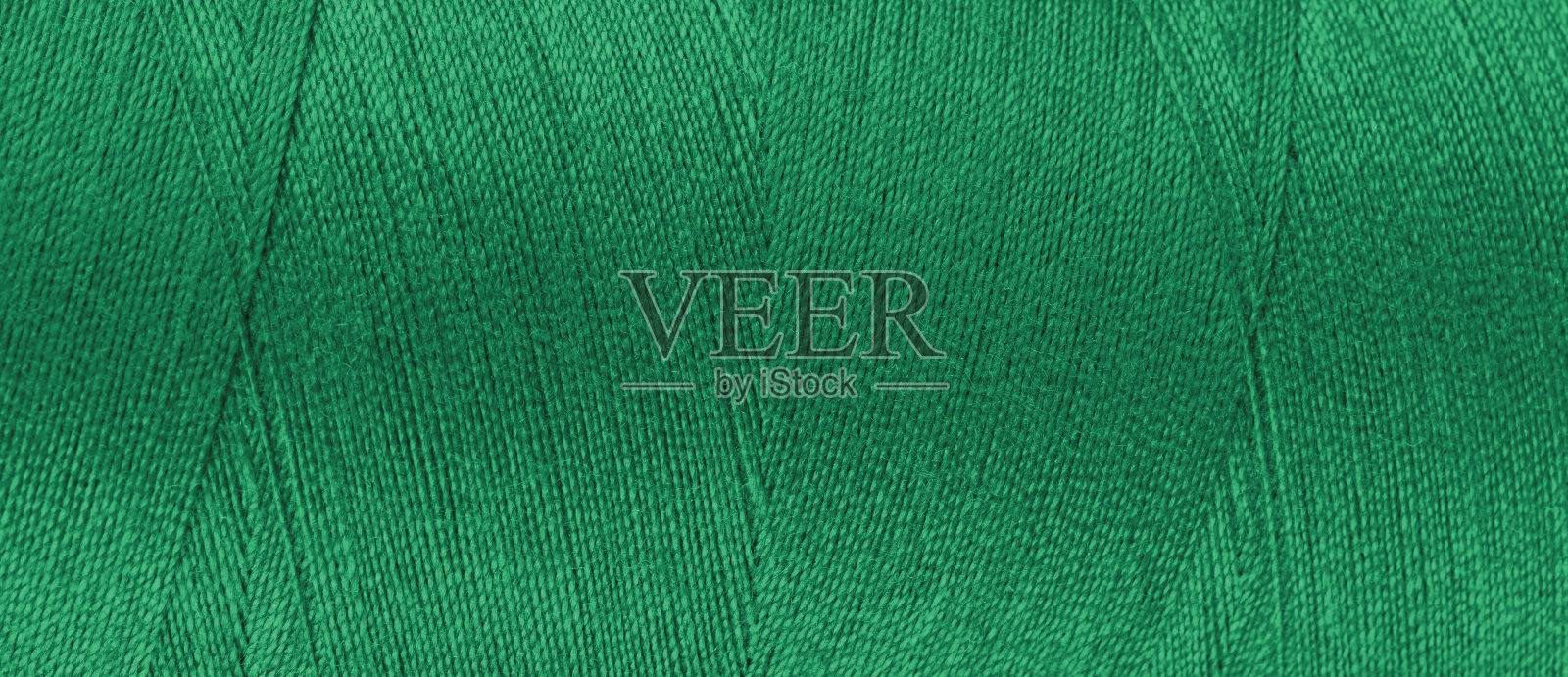 绿色线在线轴上的纹理接近，宏观。宽横幅、页眉照片摄影图片