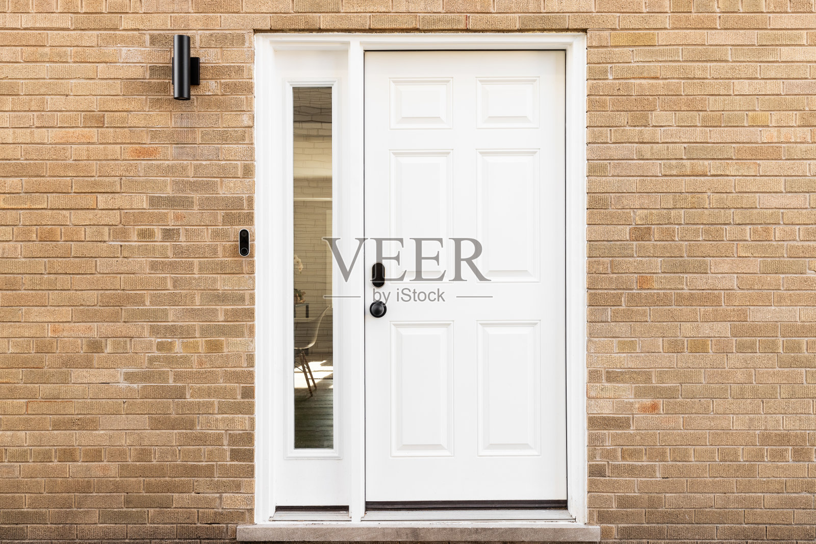 白色的前门带有砖砌外墙。照片摄影图片