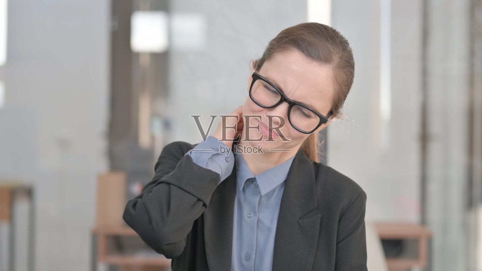 办公室里脖子疼的年轻女商人肖像照片摄影图片