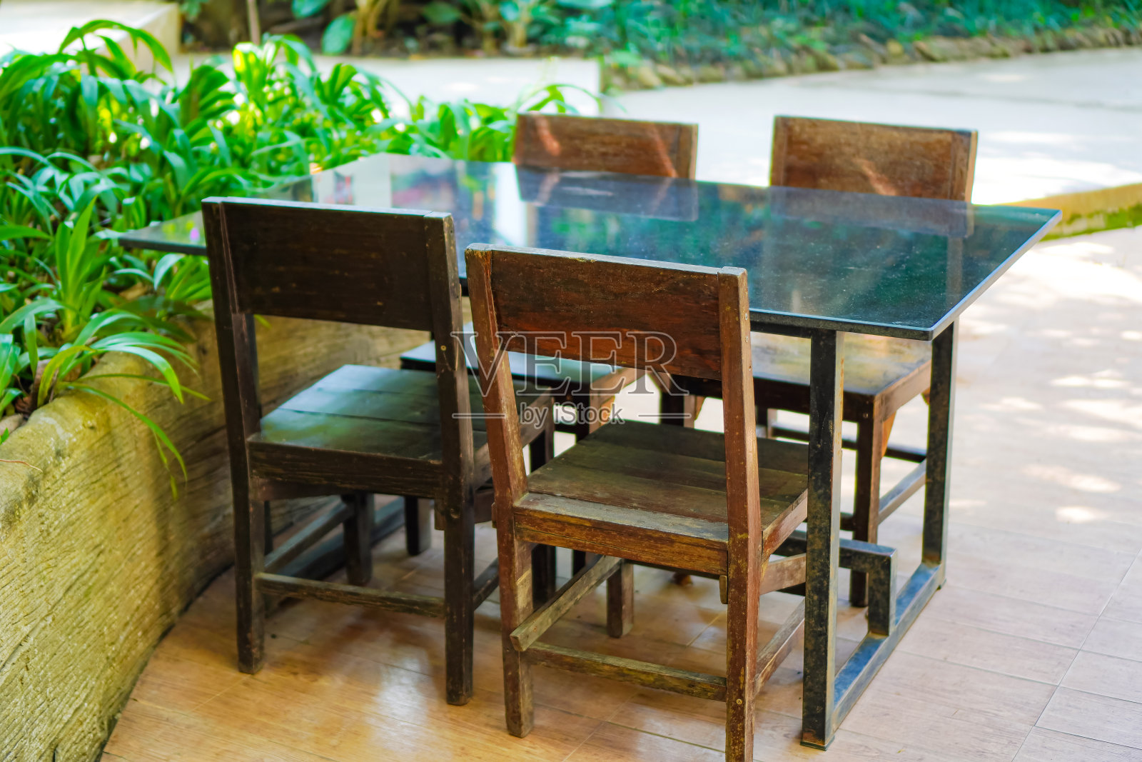 在自然氛围中为4人设置的木制餐桌的图片。照片摄影图片