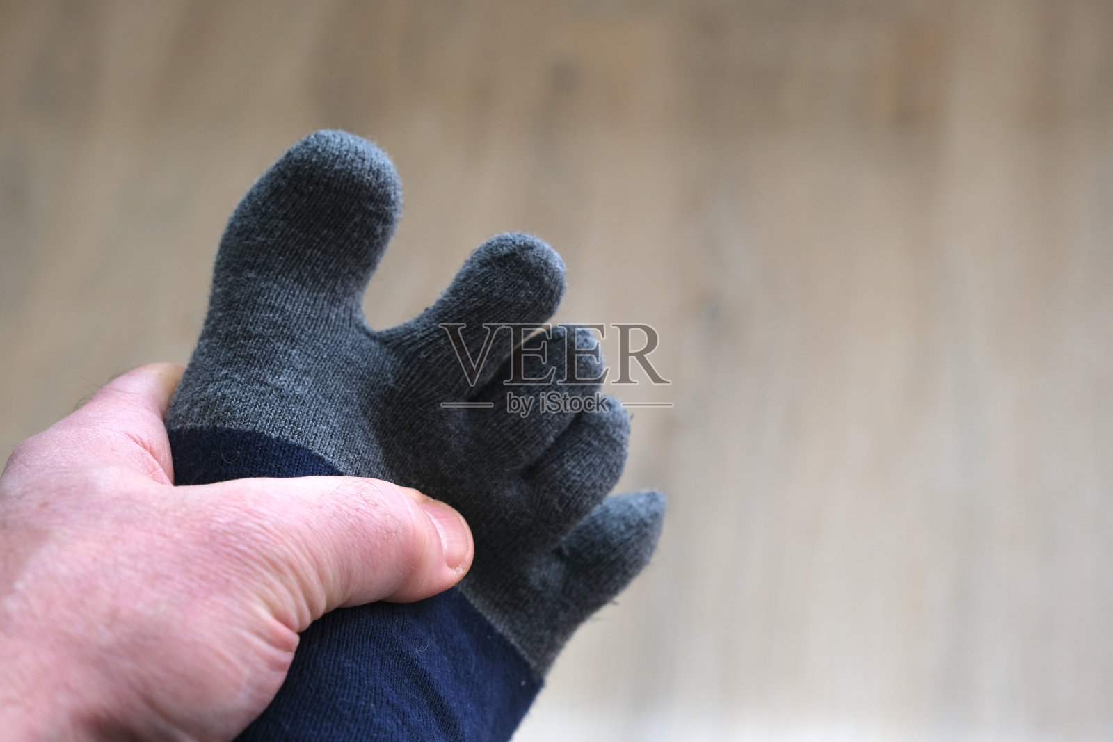 一只手把一只脚套在袜子里照片摄影图片