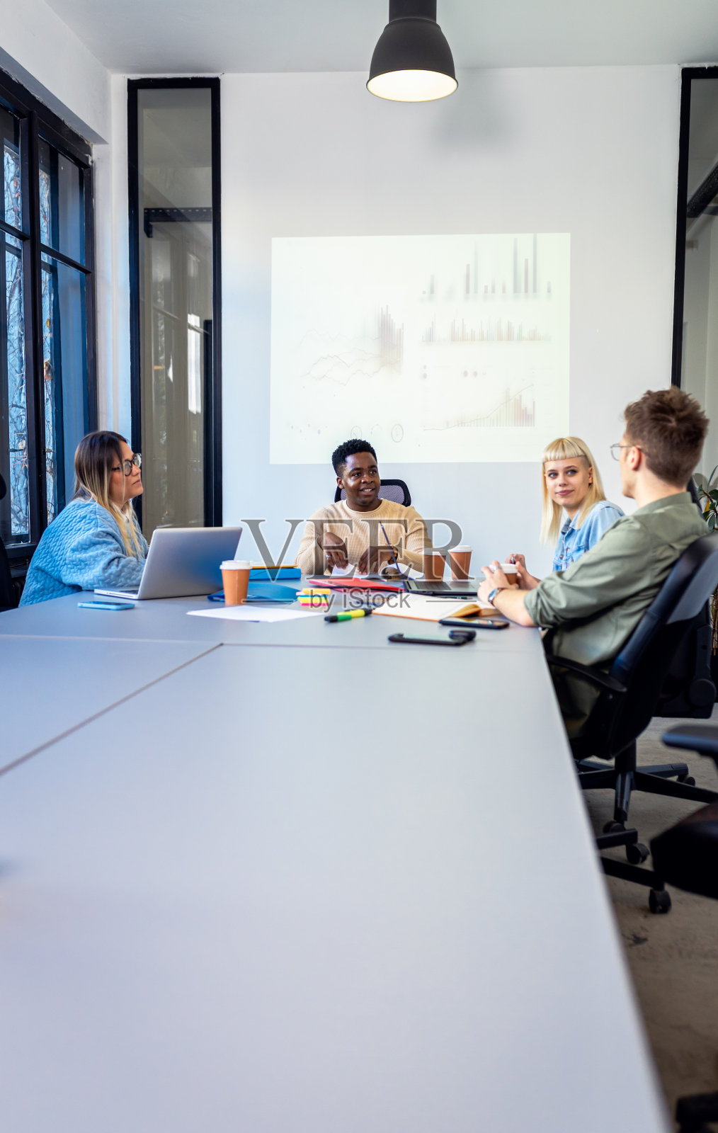 一群不同的年轻商人在办公室里一起做新项目。照片摄影图片