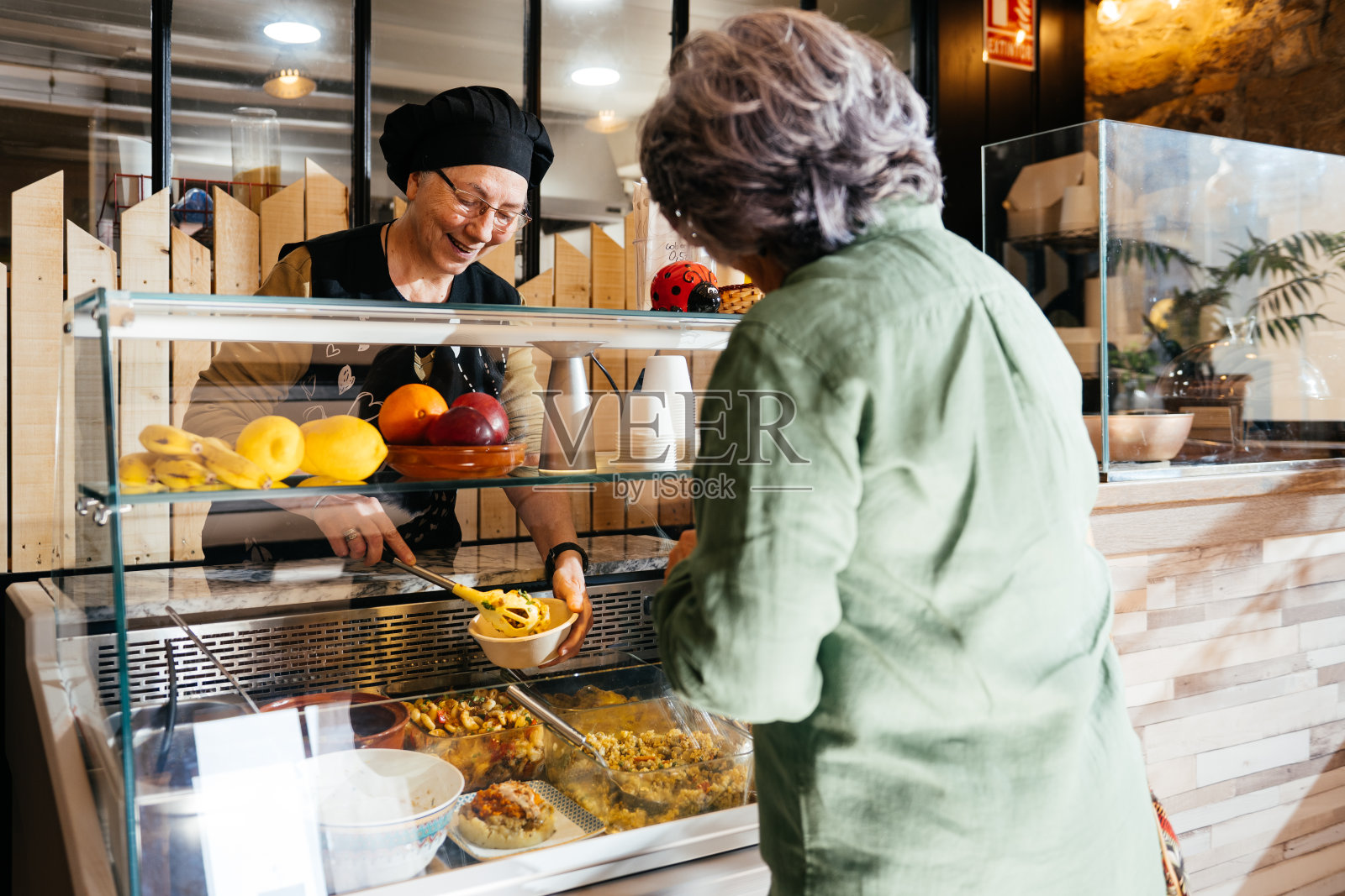 繁忙的午餐时间，外卖柜台的友好交流照片摄影图片
