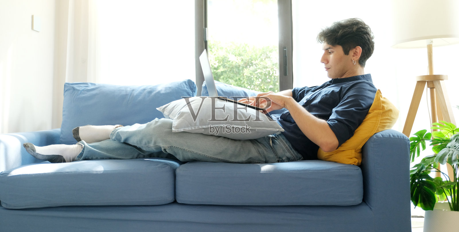 年轻人在家用笔记本电脑工作，在家工作，在线学习照片摄影图片