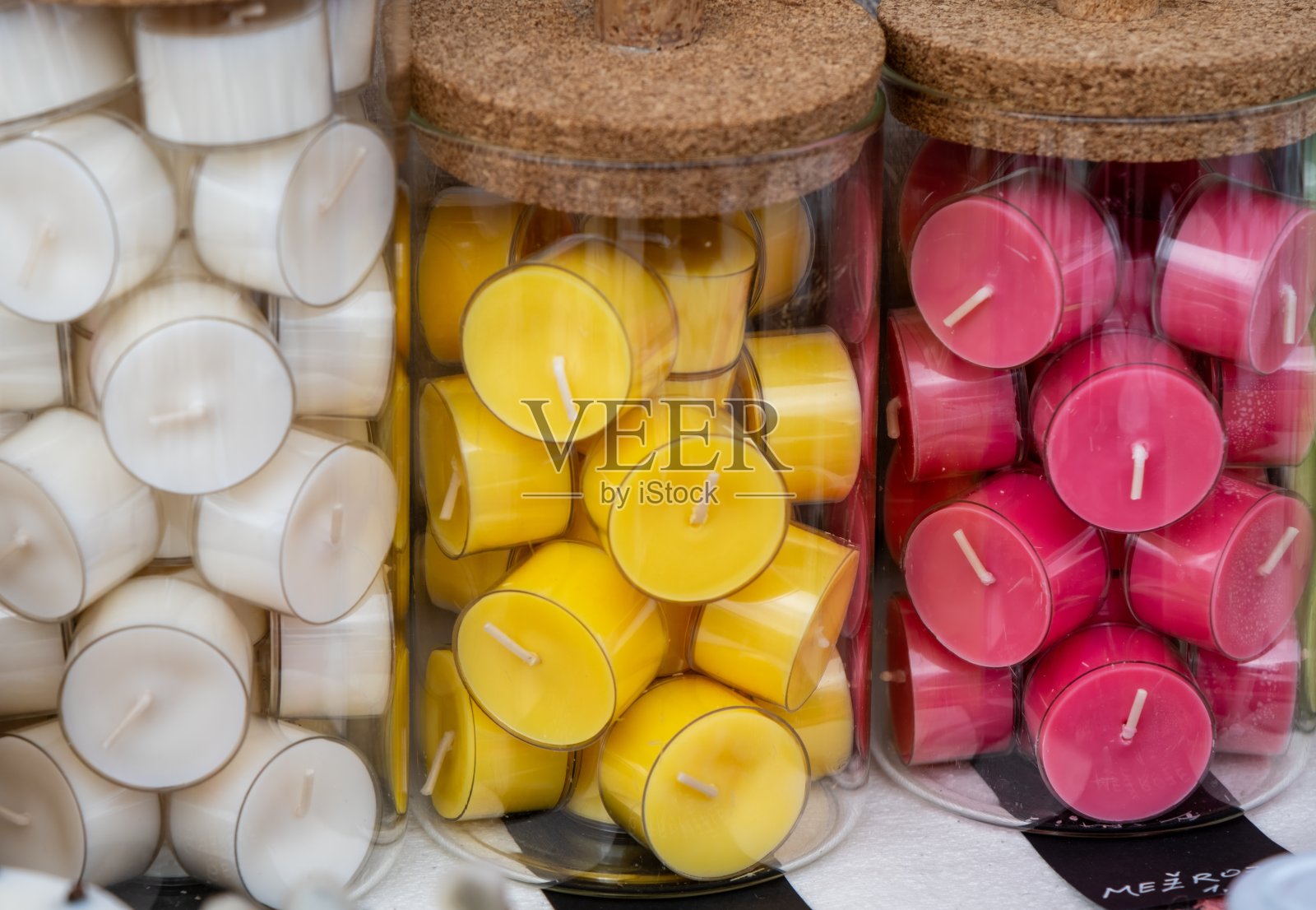 木桌上放着黄、红、绿三种颜色的蜡烛照片摄影图片