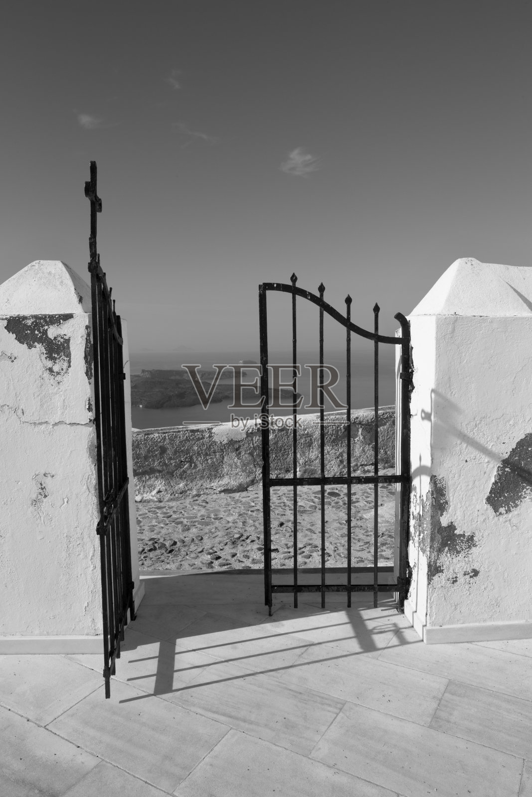 圣托里尼-伊莫罗维里教堂的大门，可以看到尼亚卡梅尼火山岛。照片摄影图片