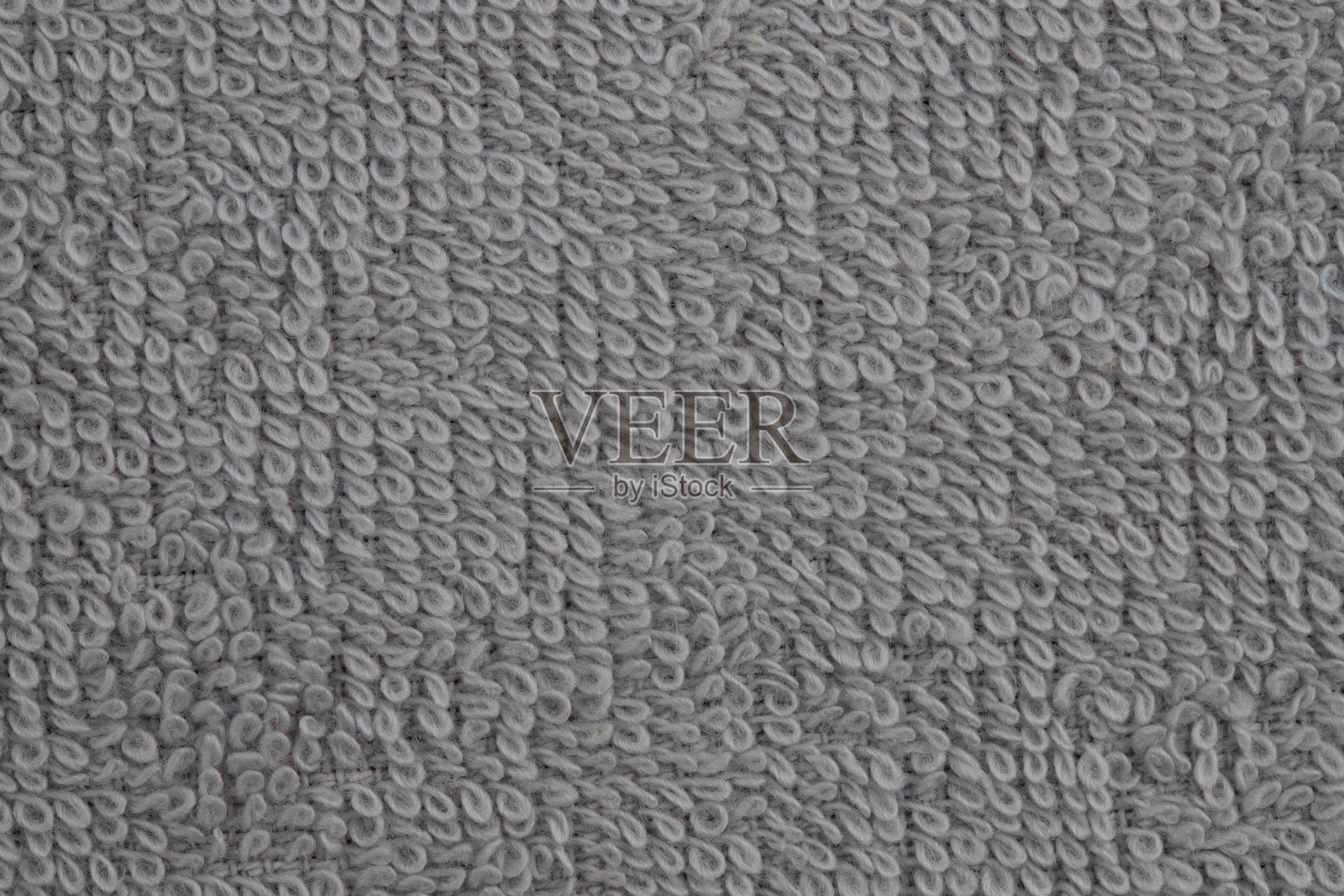 五颜六色的毛巾，卷起来堆放在桌子上照片摄影图片