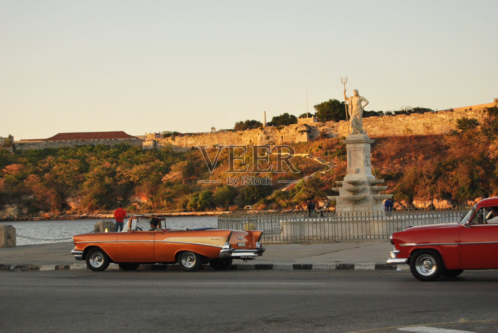 海王星的雕像和前景的经典汽车照片摄影图片
