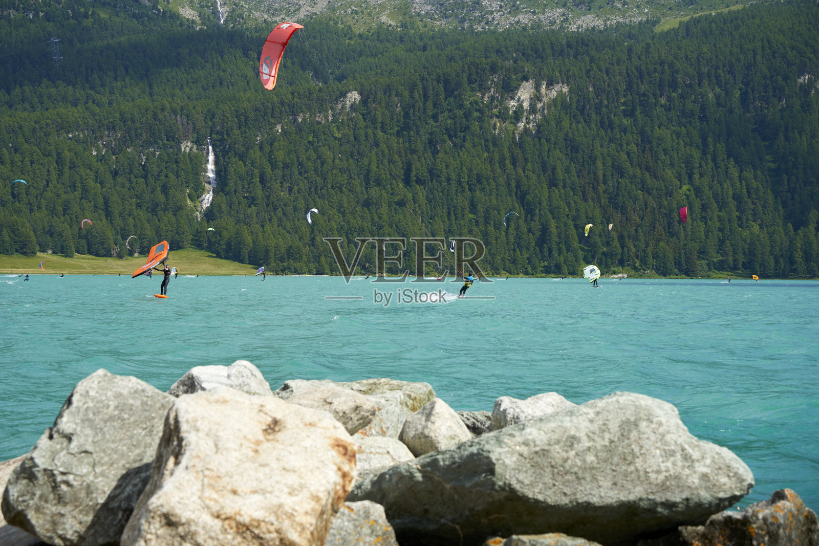 在山上的湖上度过闲暇时光。水上运动爱好者享受他们的激情。晴朗的夏日。瑞士圣莫里茨恩加丁的西尔瓦普拉纳湖。照片摄影图片