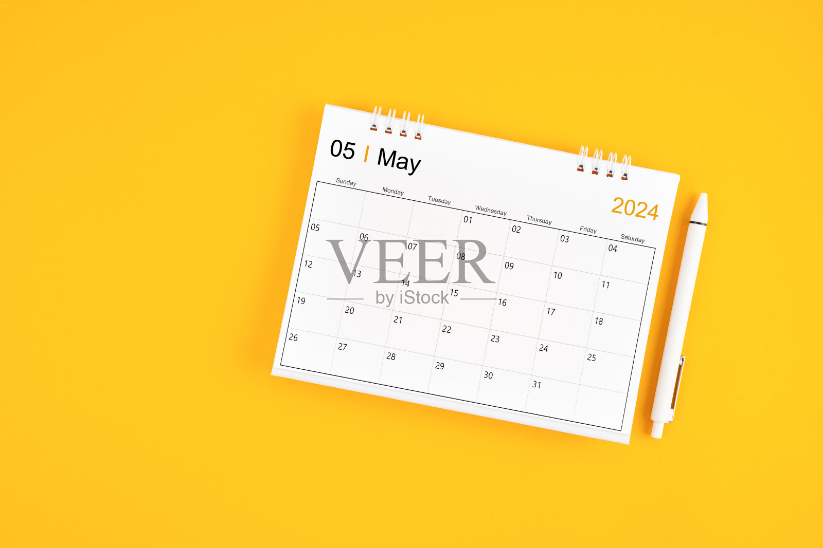 2024年5月，2024年月历和黄色背景笔。照片摄影图片
