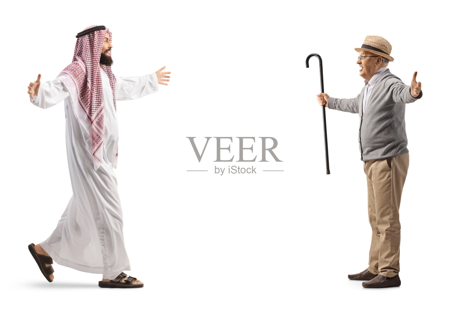 穿着传统服装的沙特阿拉伯男子正在会见一位年长的男子照片摄影图片