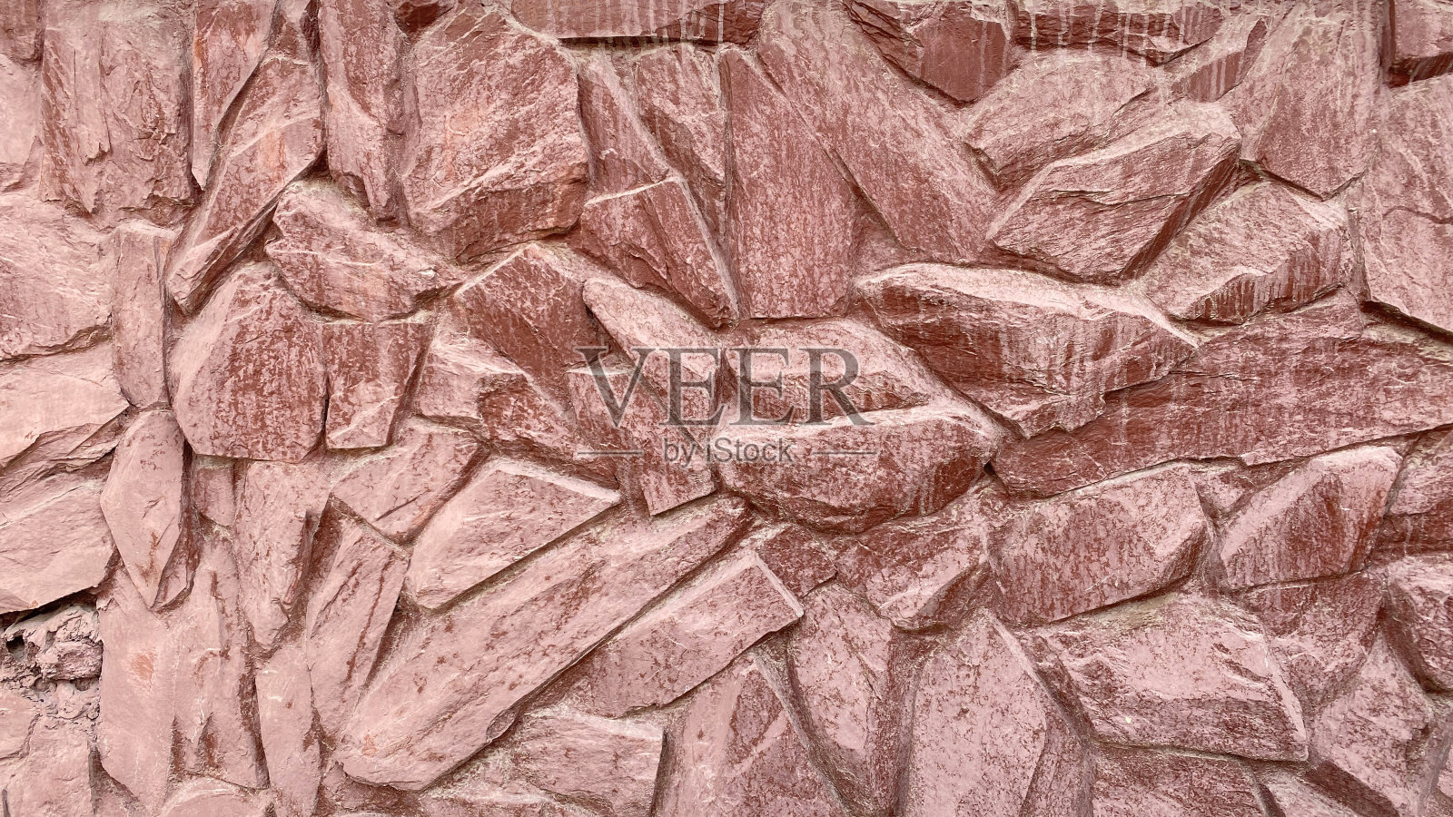 大小不一的美丽的红色石墙。砌筑的纹理照片摄影图片