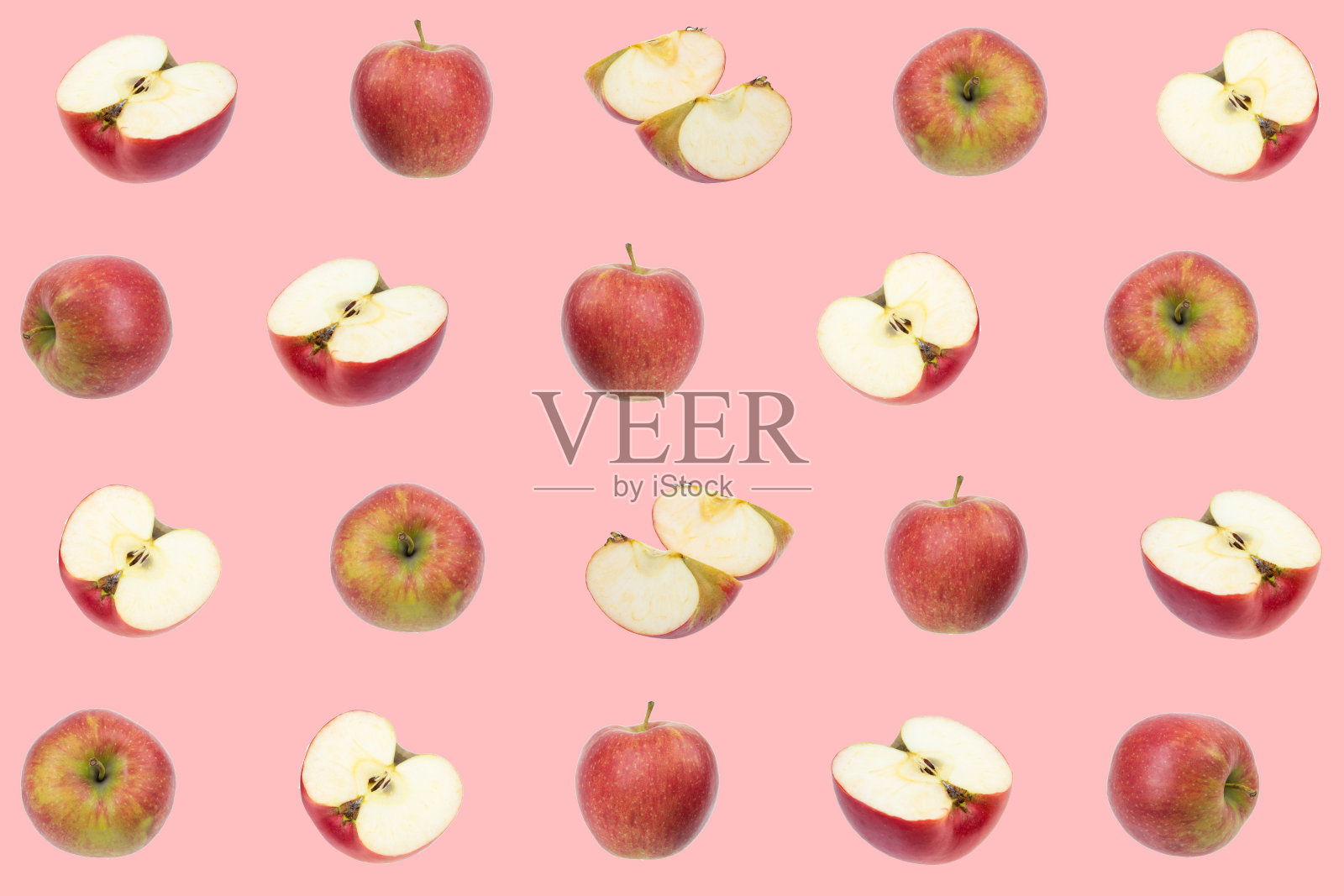 鲜艳的水果图案，新鲜的红色，绿色的苹果在粉红色的背景。纺织品、墙纸、织物的纹理设计。从俯视图看。照片摄影图片