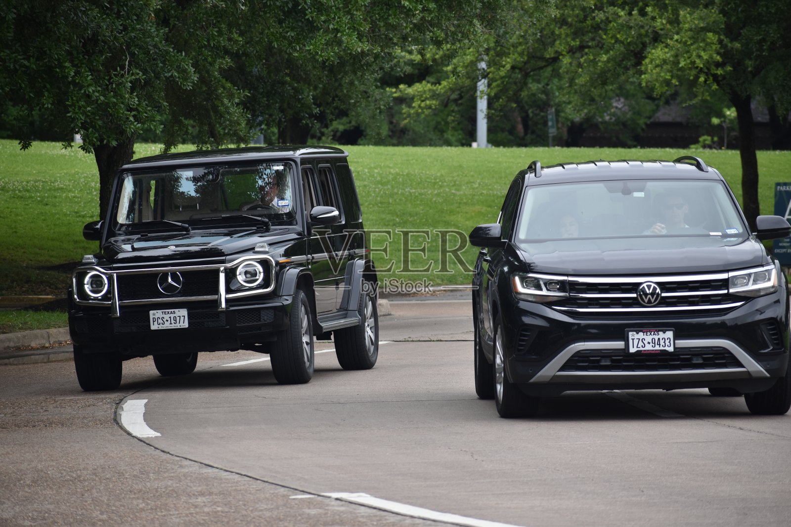 一辆奔驰G旅行车和一辆大众SUV在自然保护区附近行驶照片摄影图片