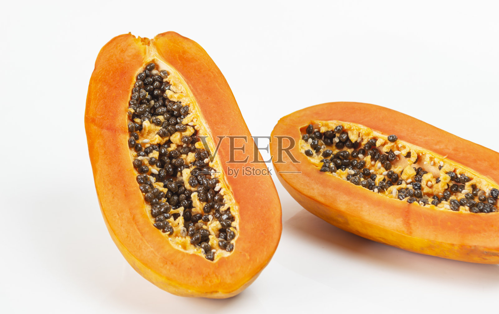 成熟的木瓜切成两半，果肉黄色照片摄影图片