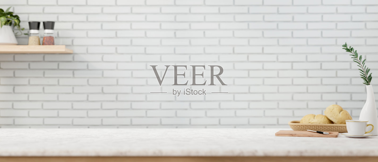 白色的厨房桌面突出了白色砖墙的展示空间。照片摄影图片