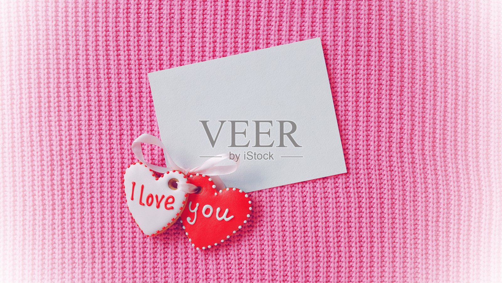 情人节贺卡。两个姜饼心形，和一个柔和的粉红色背景。俯视图照片摄影图片