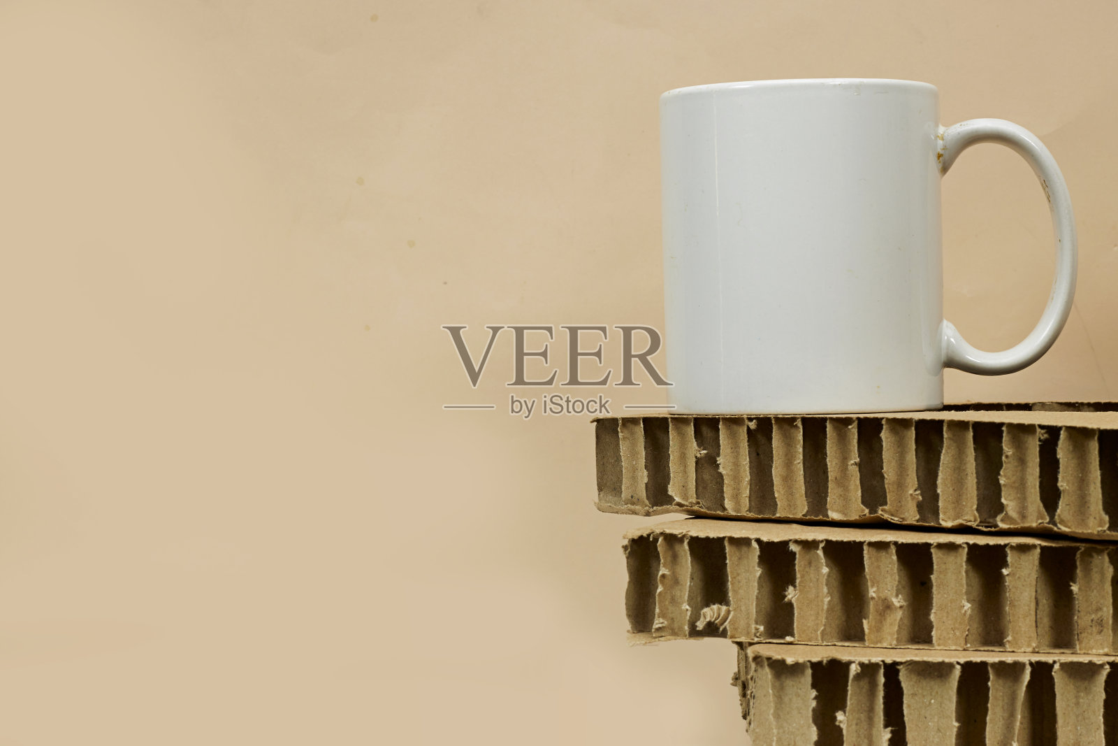 白色的咖啡杯，白色的瓷杯在纸板上的模拟照片摄影图片