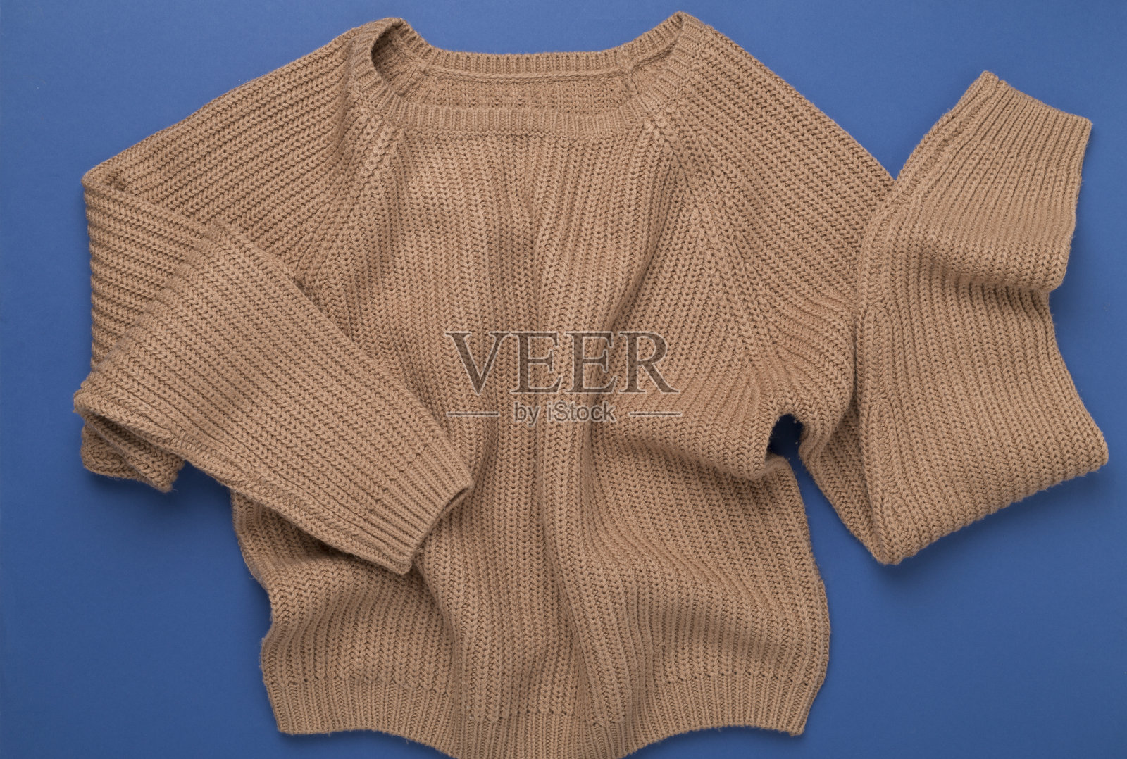 米色针织毛衣的颜色背景，俯视图照片摄影图片