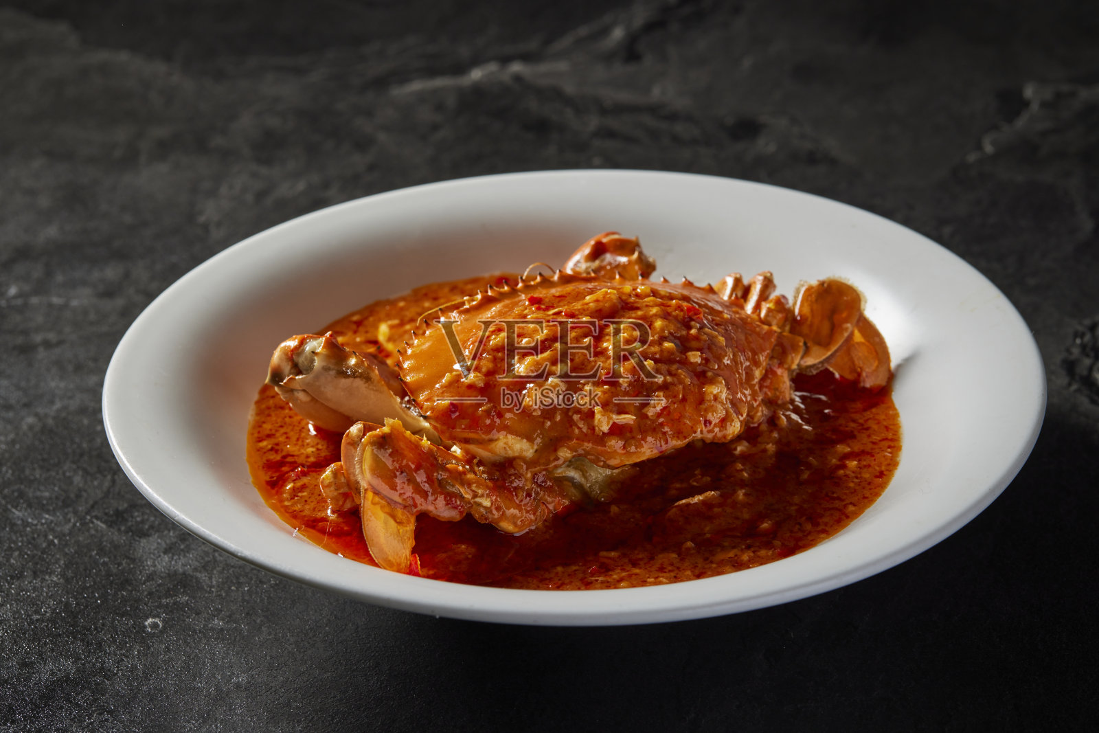 传统中式炒锅炒海鲜新鲜大肉蟹配辣椒辣咸蛋黄奶酪奶油酱盘在暗石桌亚洲咖啡厅酒店豪华清真食品餐厅宴会菜单照片摄影图片