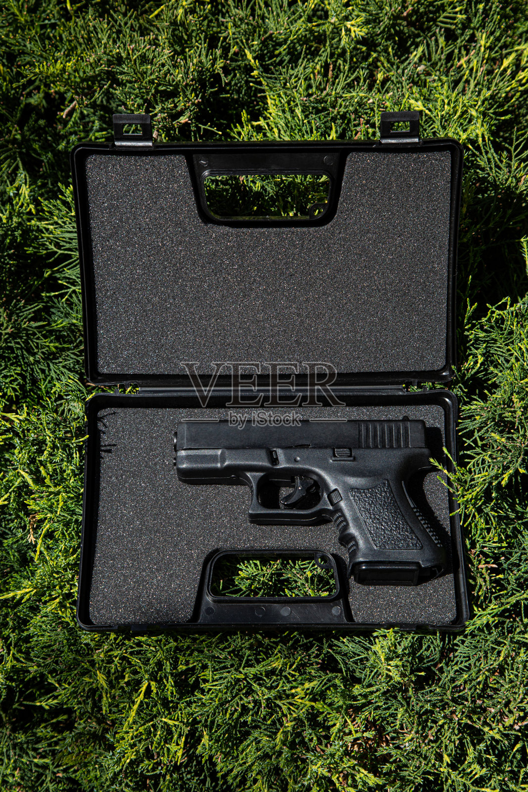 现代半自动手枪。军队和警察的军备。Short-barreled武器。绿色杉木背景。照片摄影图片