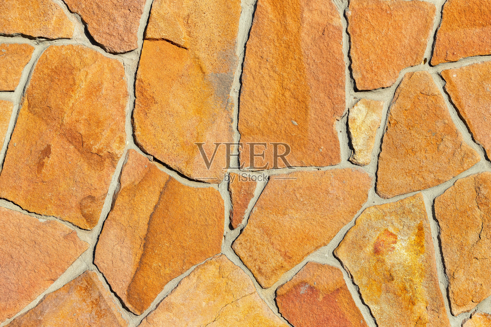 粗糙砖墙中金色砂岩砖的纹理。照片摄影图片