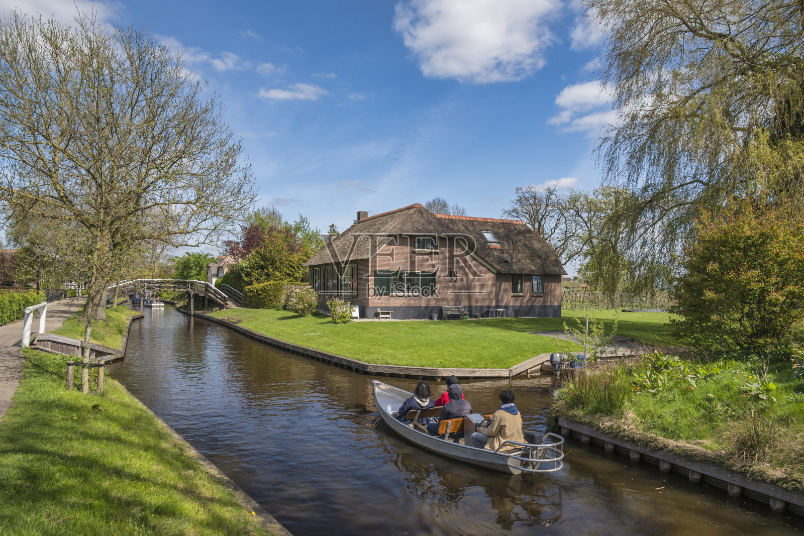 荷兰Giethoorn，游客乘船在Giethoorn村的运河上航行照片摄影图片