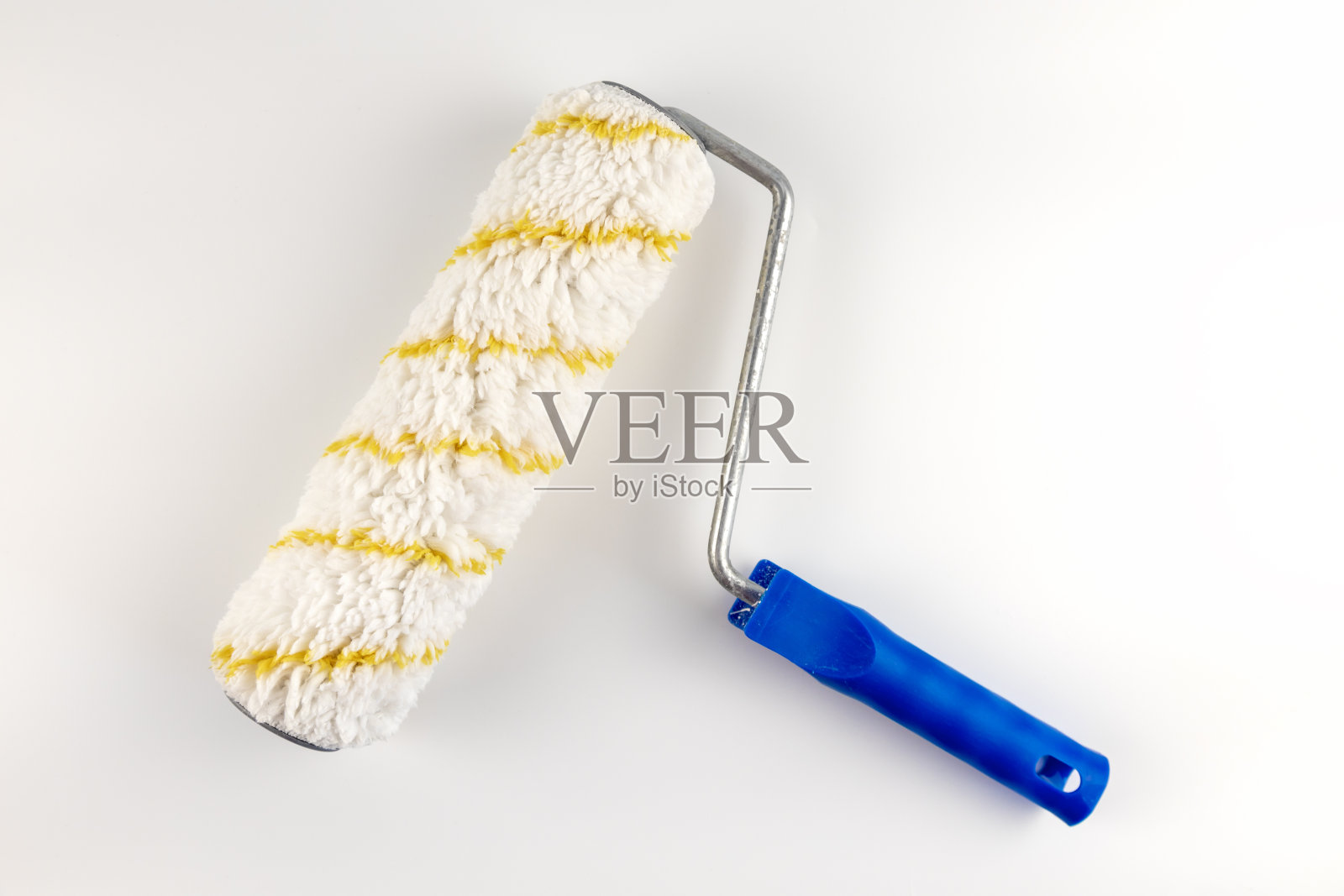 油漆滚筒被隔离在白色的背景上。照片摄影图片