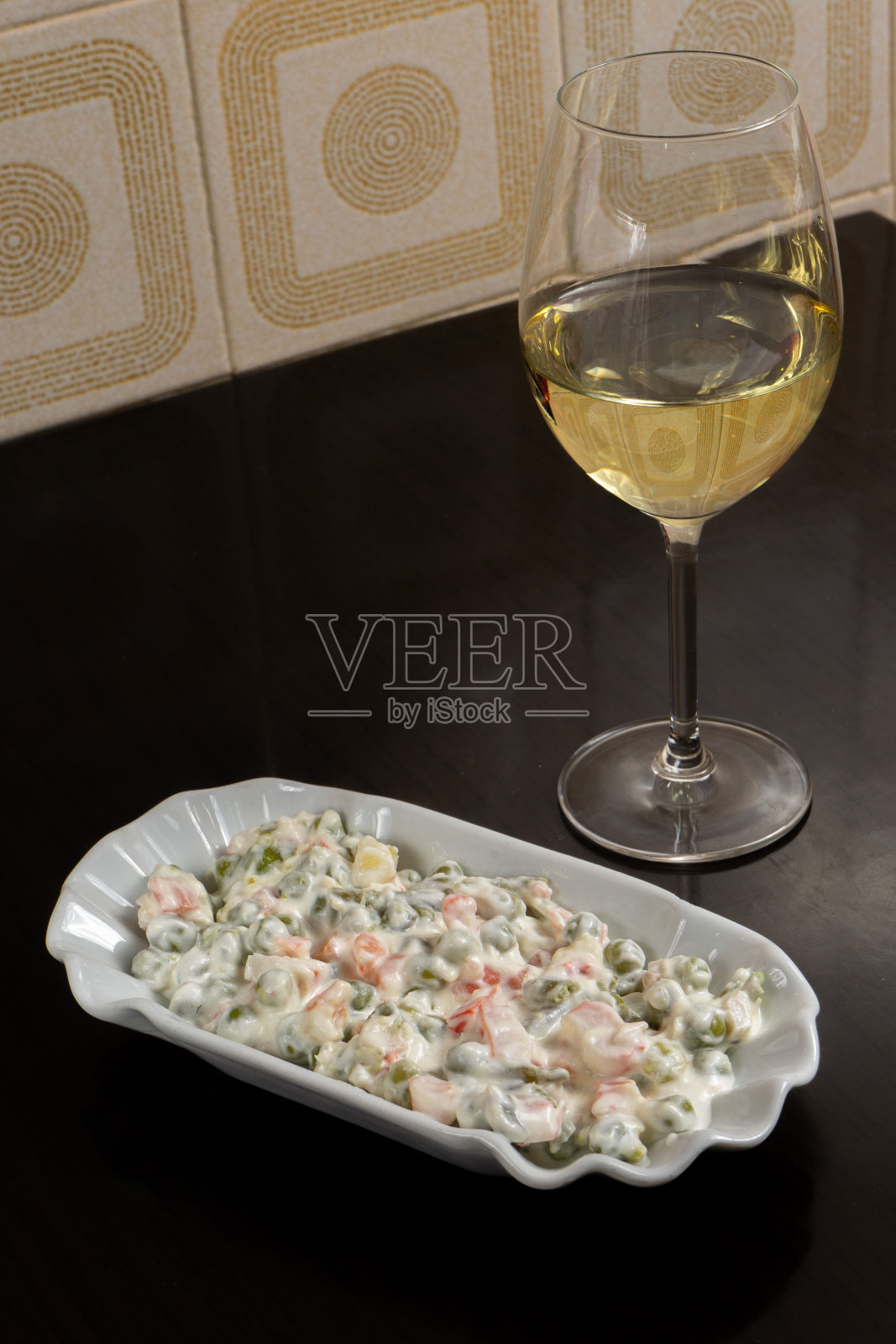 Salada Russa，配上白葡萄酒，在餐厅里展示葡萄牙的美食。照片摄影图片