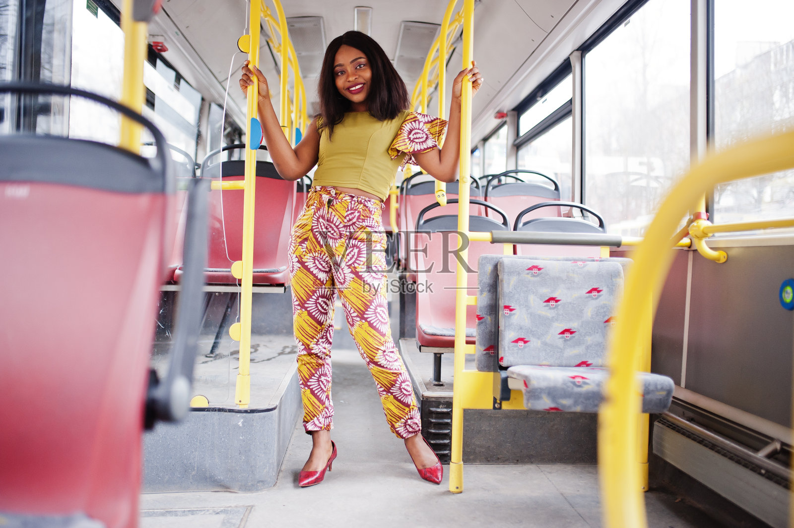 年轻时尚的非裔美国女性坐在公共汽车上。照片摄影图片