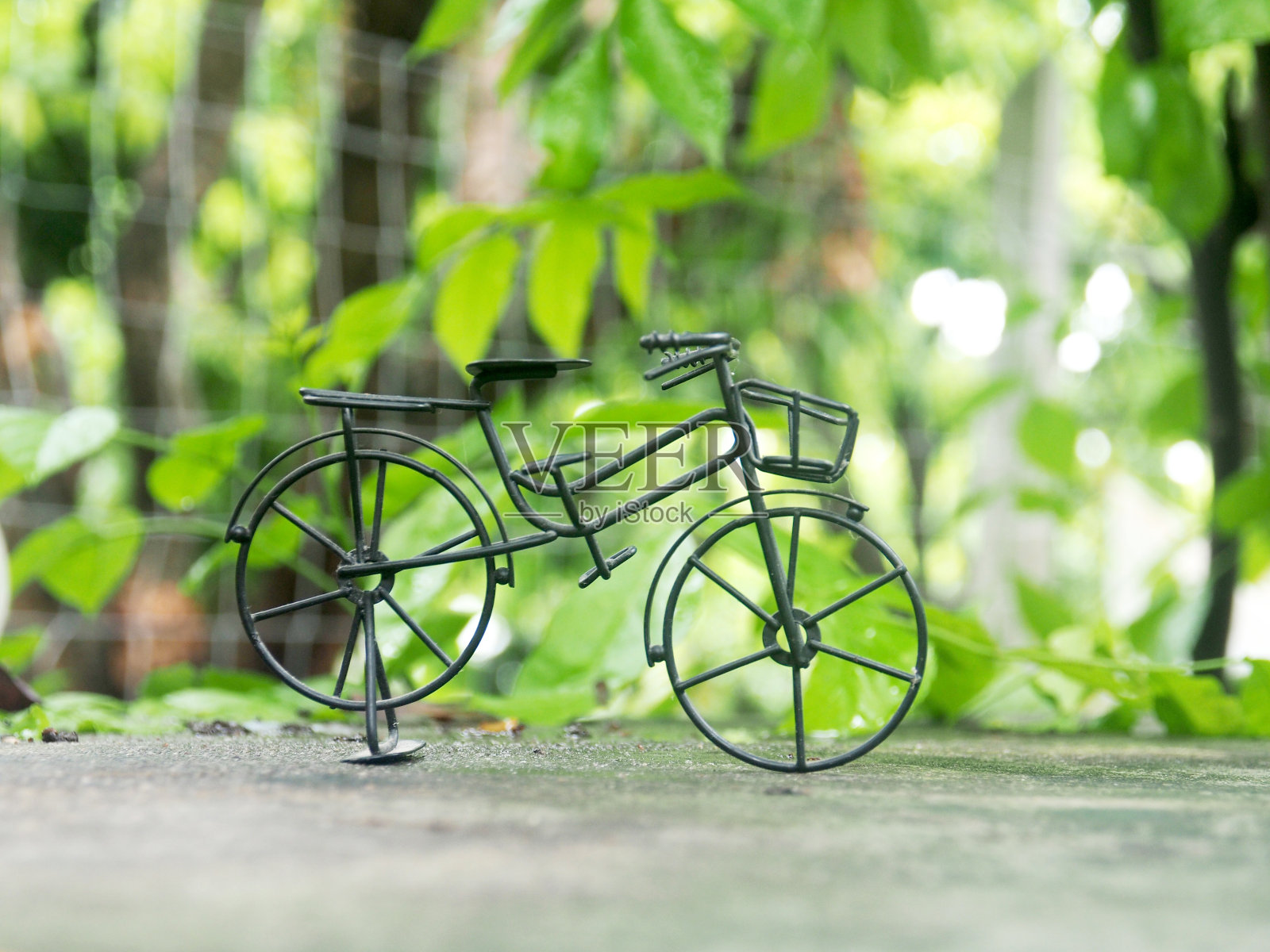 自行车模型玩具装饰在绿色花园和散景背景照片摄影图片