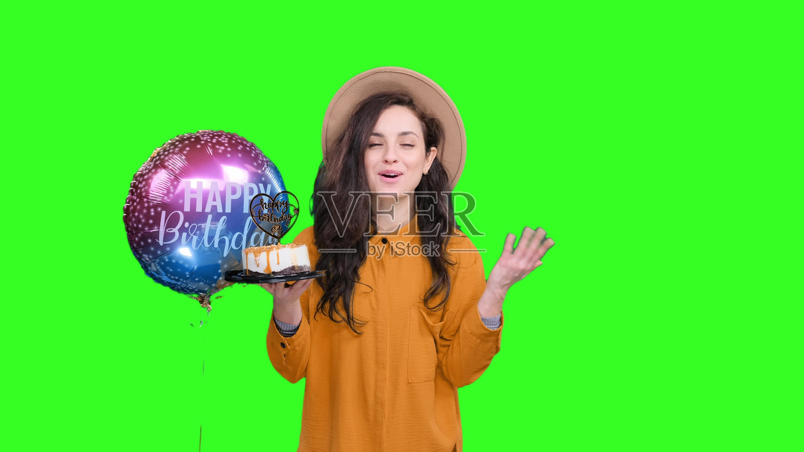 快乐的女人庆祝生日，在色度键上拿着蛋糕照片摄影图片