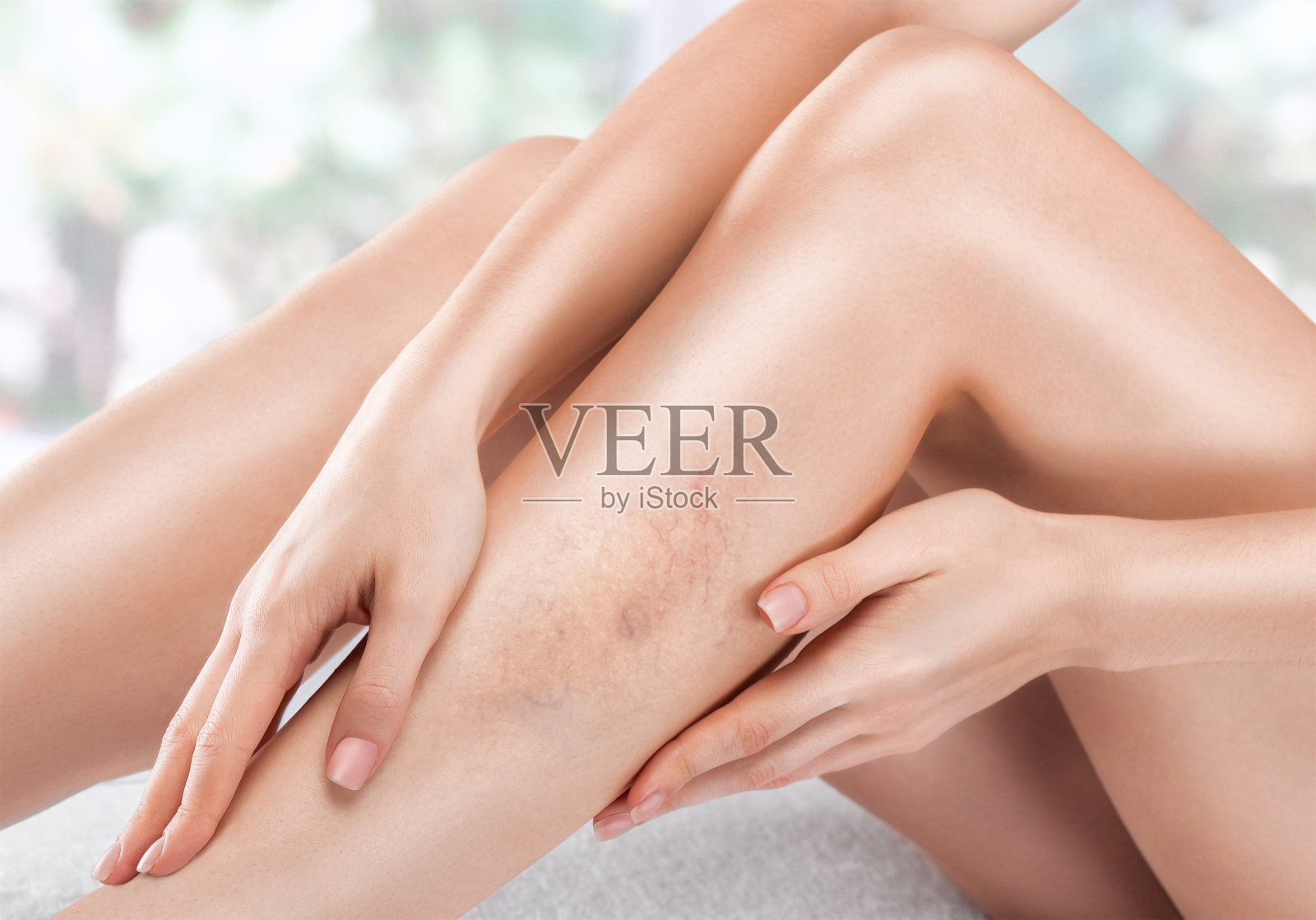 一名妇女在spa沙龙为脚敷面膜，防止干燥、脚后跟皮肤皲裂和疲劳。照片摄影图片