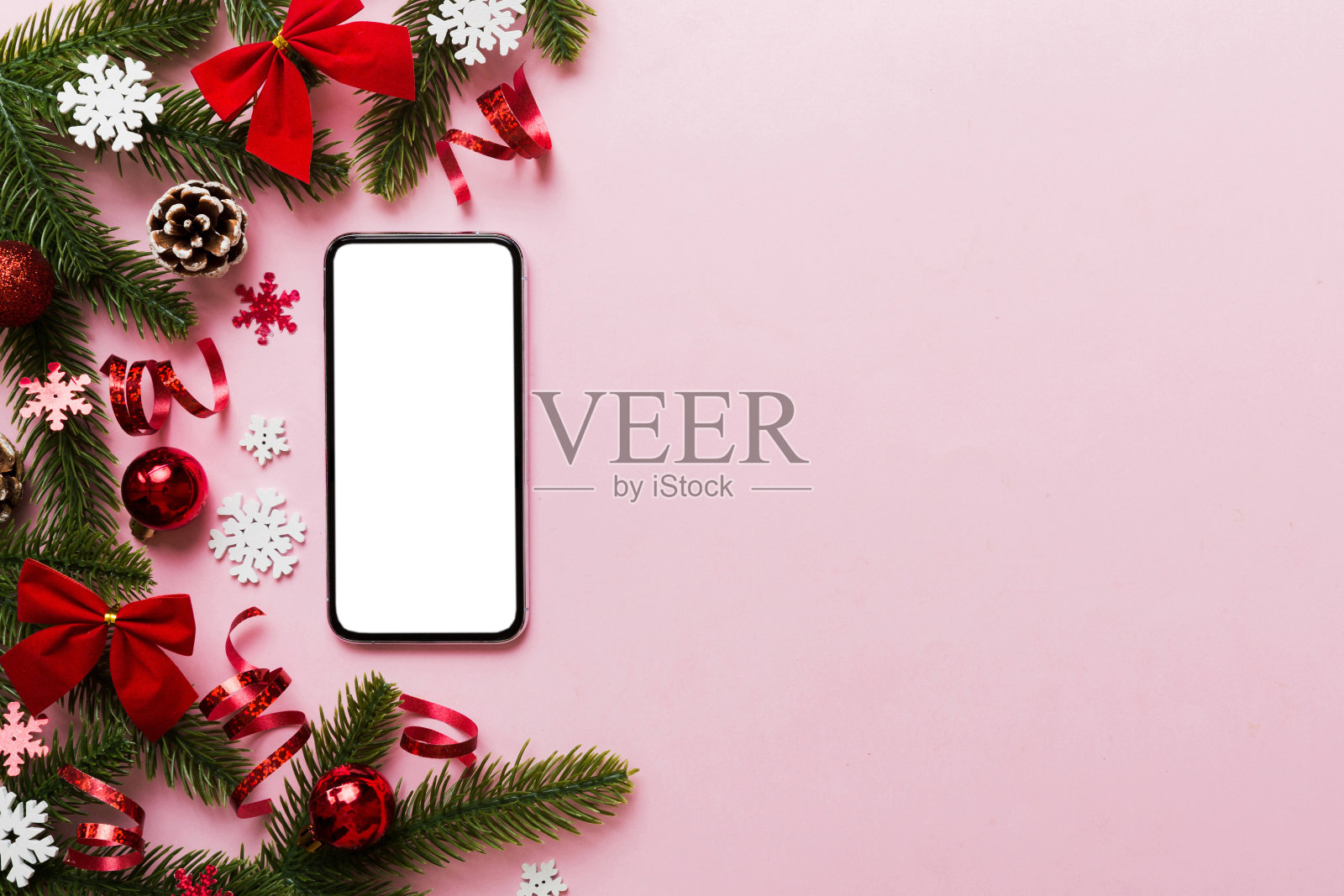 带圣诞装饰的数字手机模型，顶部视图，留有设计空间。圣诞节在线购物概念。照片摄影图片