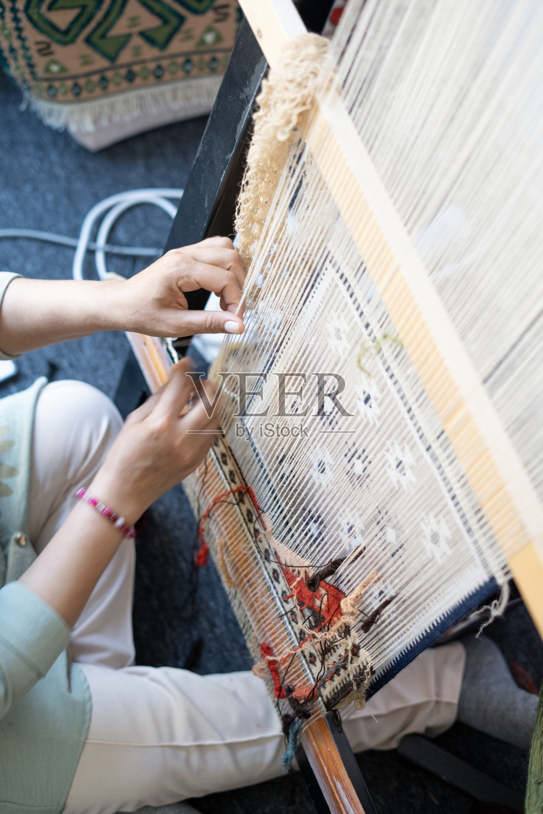 (特写)车间里，成年妇女的手在制作地毯照片摄影图片