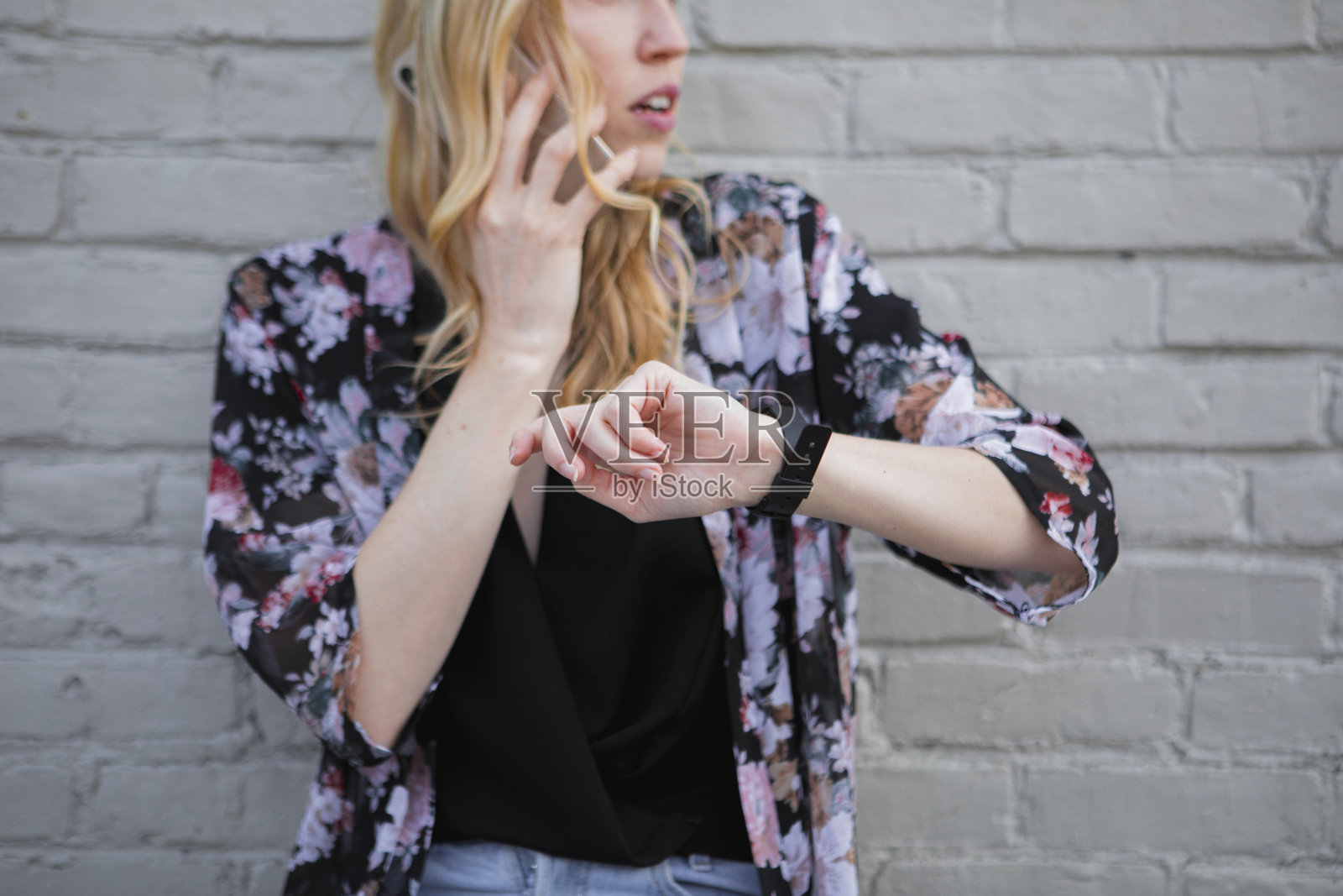 打电话迟到的女人看表照片摄影图片