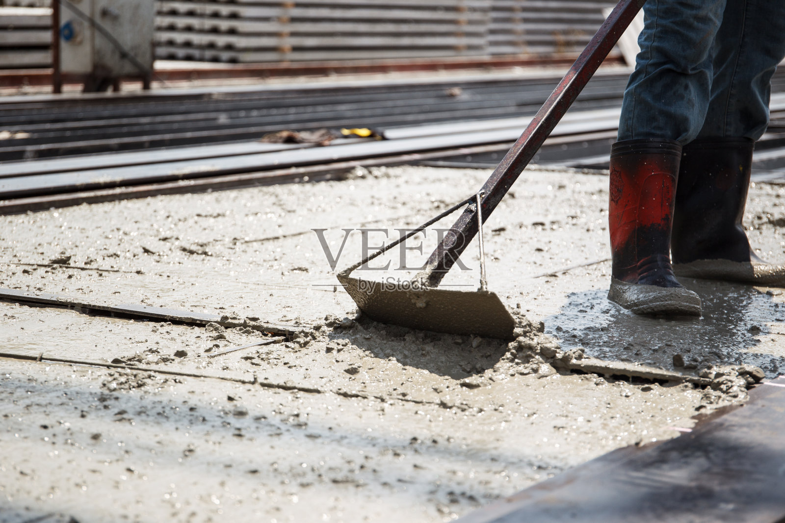 工人们正在向钢筋金属结构砌块浇筑混凝土。照片摄影图片