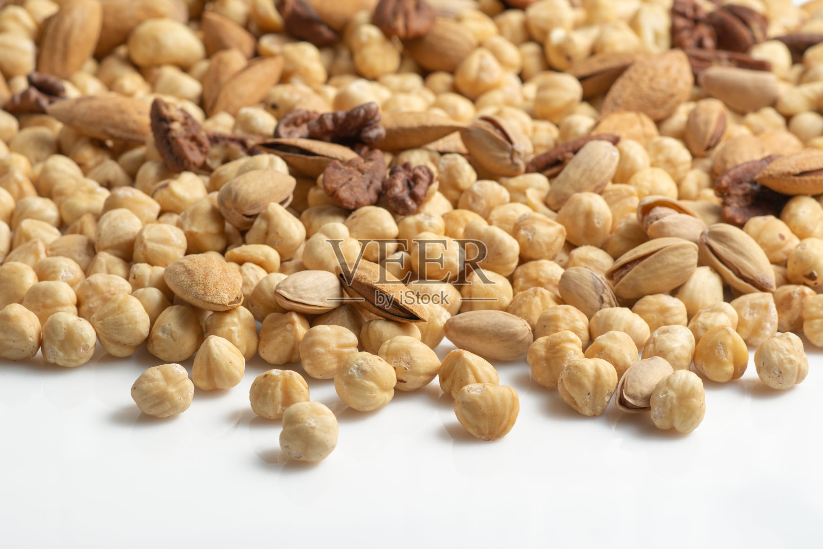 白色背景各式坚果和种子:核桃，杏仁，榛子，腰果，开心果照片摄影图片