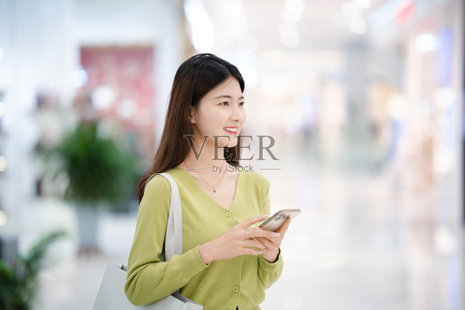 亚洲年轻美女在购物中心购物照片摄影图片