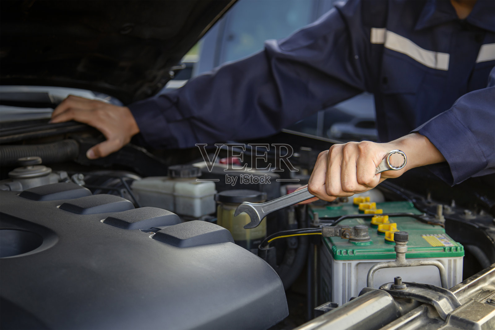 机械师在车库里修理汽车的发动机，提供汽车维修服务。照片摄影图片