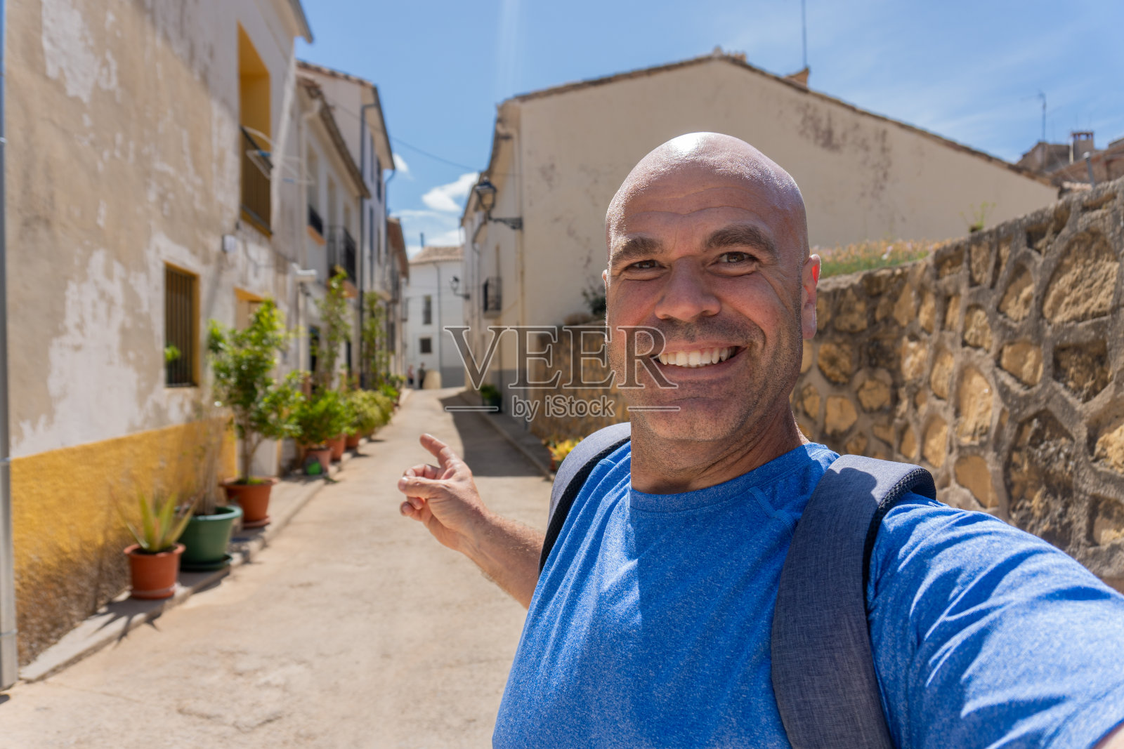 快乐的男人是一个游客在镇上的街道上自拍照片摄影图片